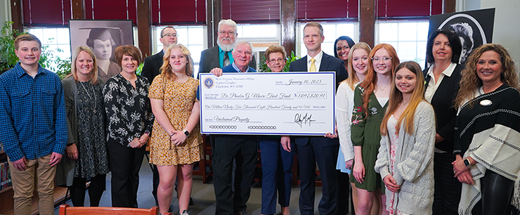 State Treasurer Riley Moore pictured with Phil Prichard - President of the Dr. Phoebia G. Moore Memorial Trust Fund - city and county officials, and Mannington Middle School students and staff.